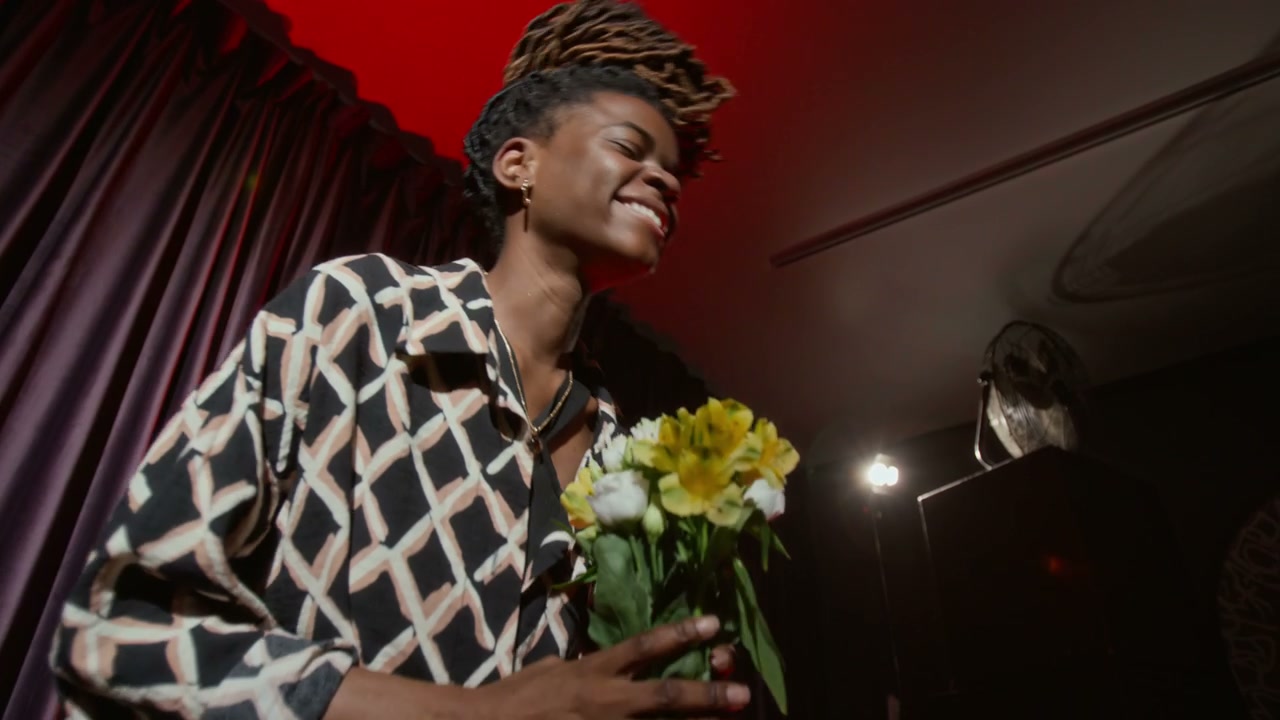 Black Woman Comedian Receiving Flowers On Stage