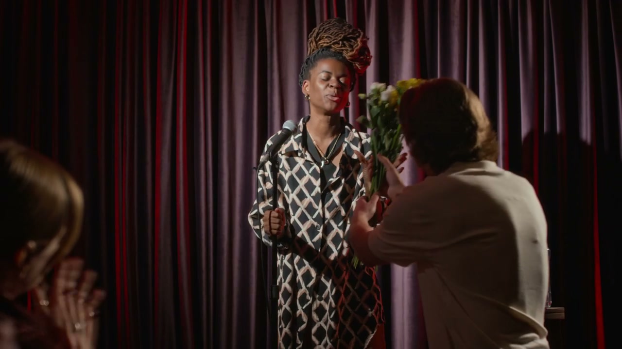 Woman Accepts Flowers After Stand-Up Performance