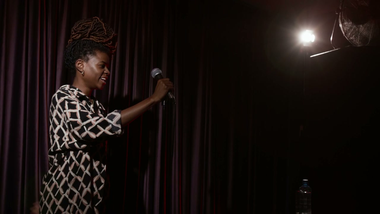 Comedian Handing Over Microphone On Stage