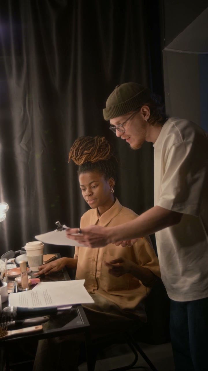 Performers Reviewing Script Backstage