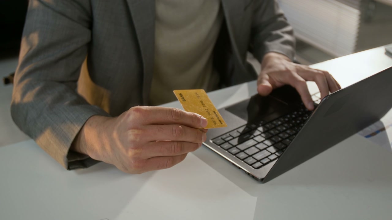 Person Using Laptop for Online Credit Card Payment
