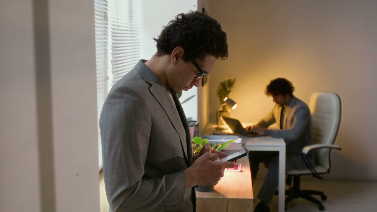 Businessman Using Smartphone in Office