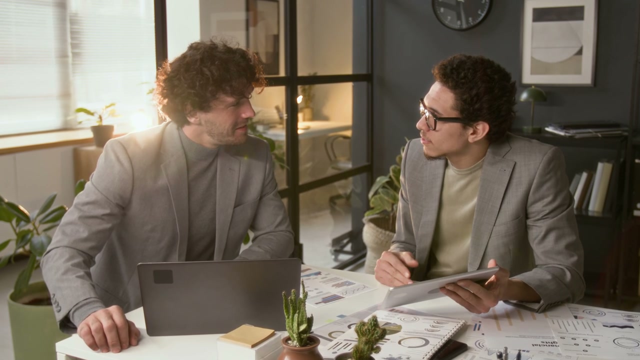 Businessmen Discussing Data In Office Meeting