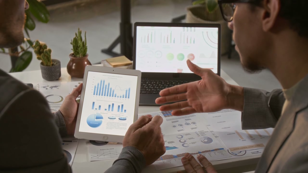 Two Businessmen Discussing Data