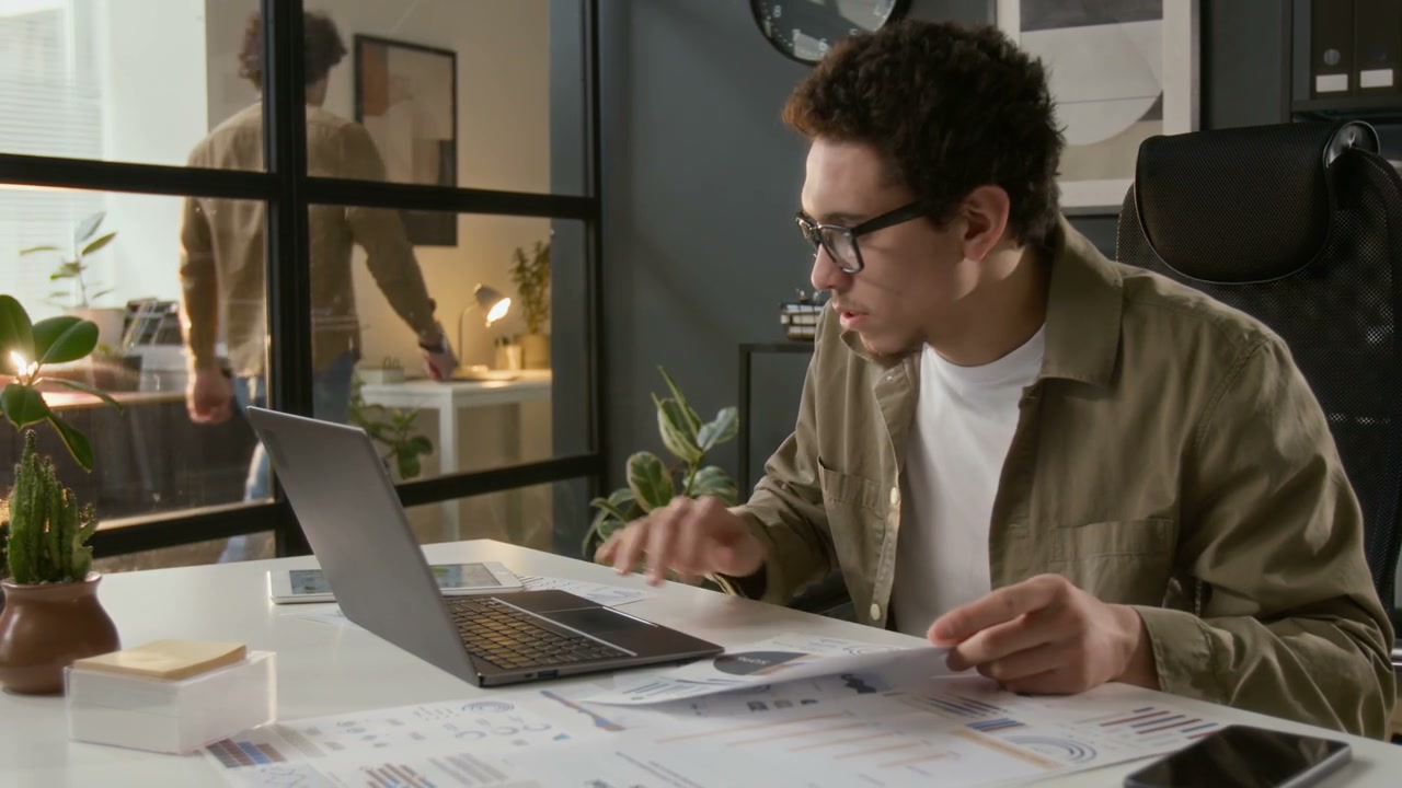 Young Businessman Working on Laptop in Office
