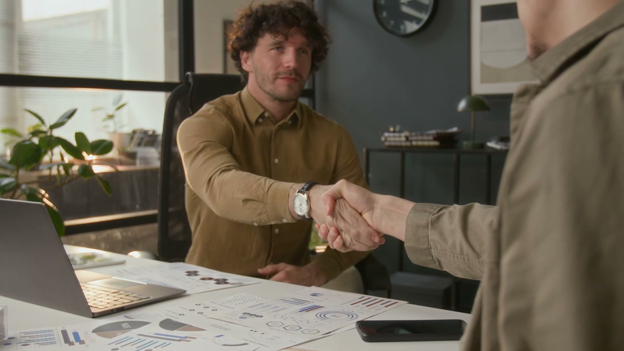 Businessmen Shake Hands in Modern Office