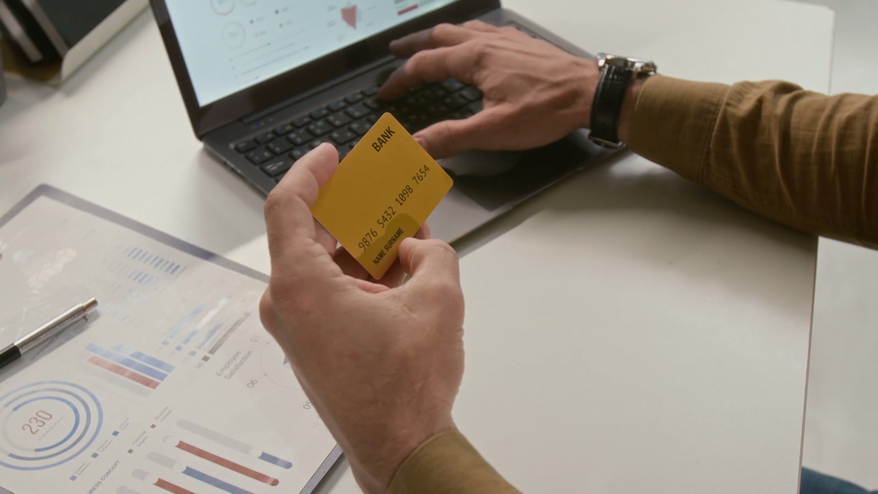 Person Making Online Payment on Laptop