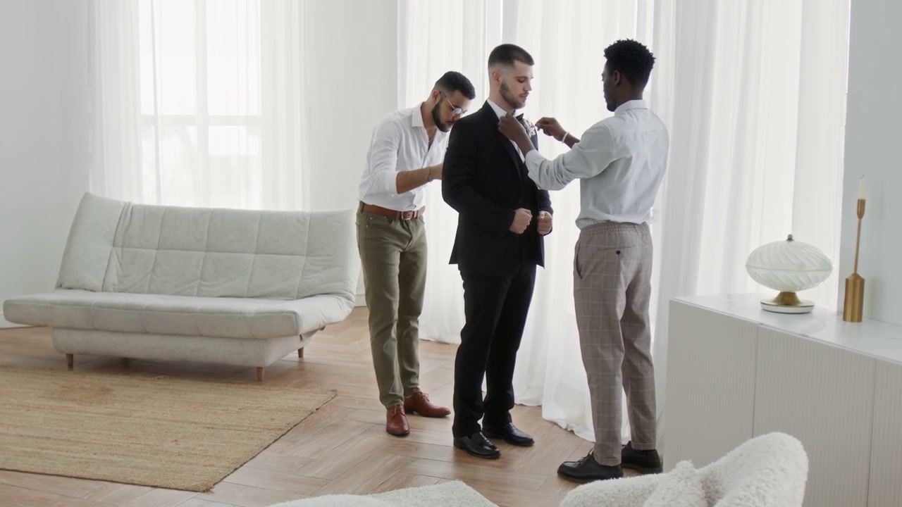 Groom Preparing for Wedding with Groomsmen
