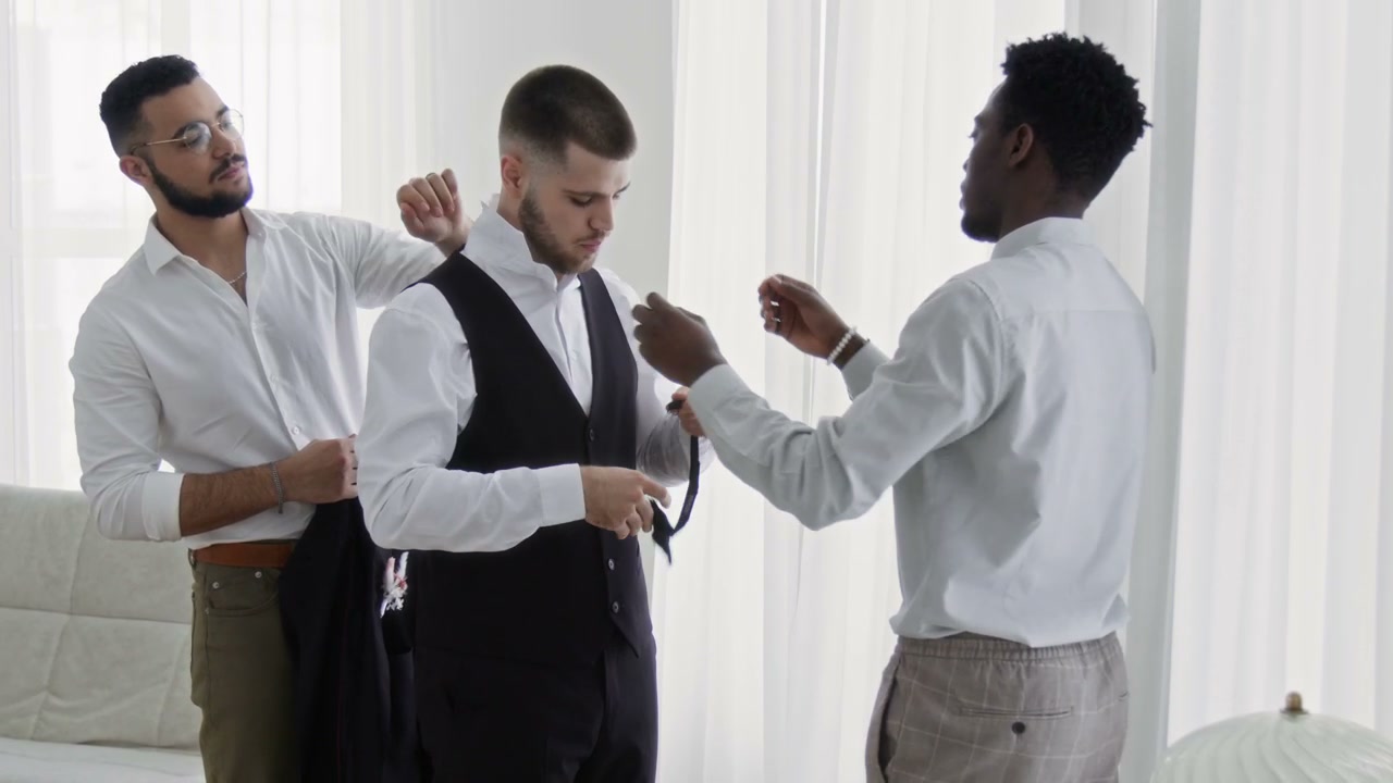 Groomsmen Helping Groom Prepare for Wedding
