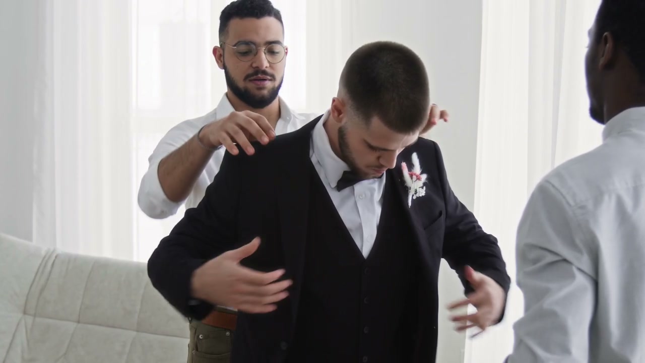 Groom And Friends Preparing For Wedding