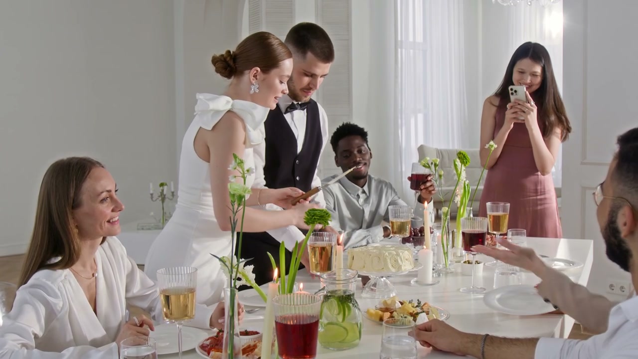 Wedding Couple Slicing Cake with Guests