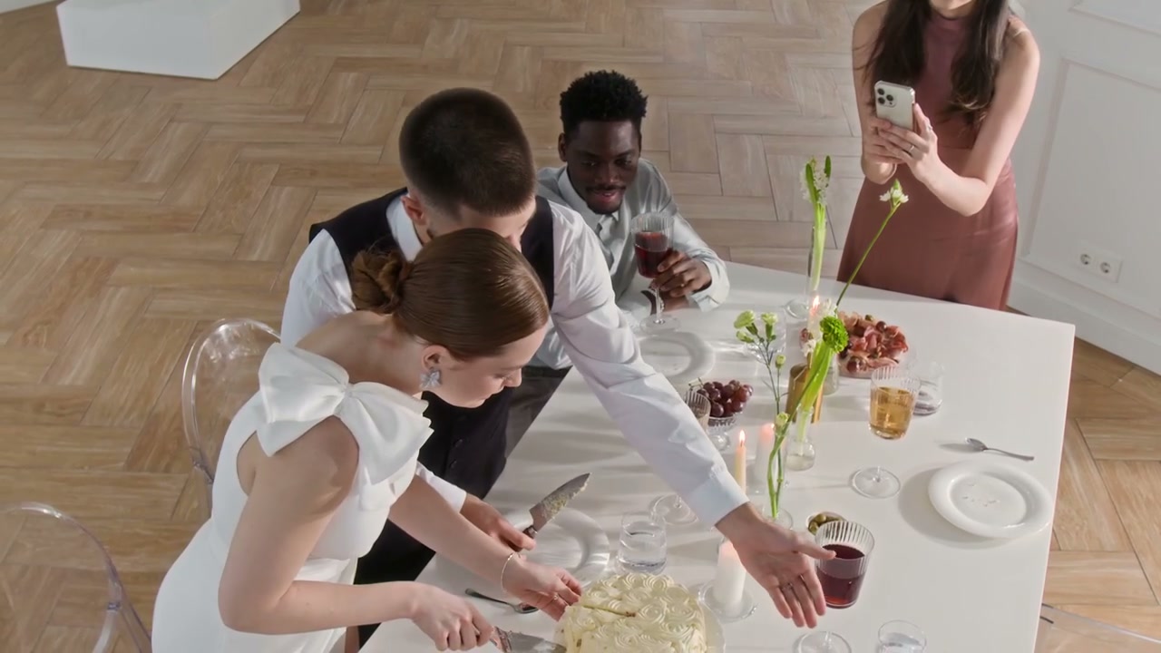 Couple Cuts Wedding Cake at Celebration