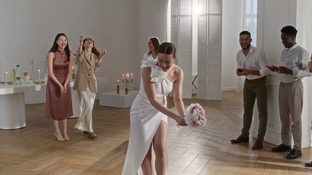 Bride Tossing Bouquet at Wedding Celebration