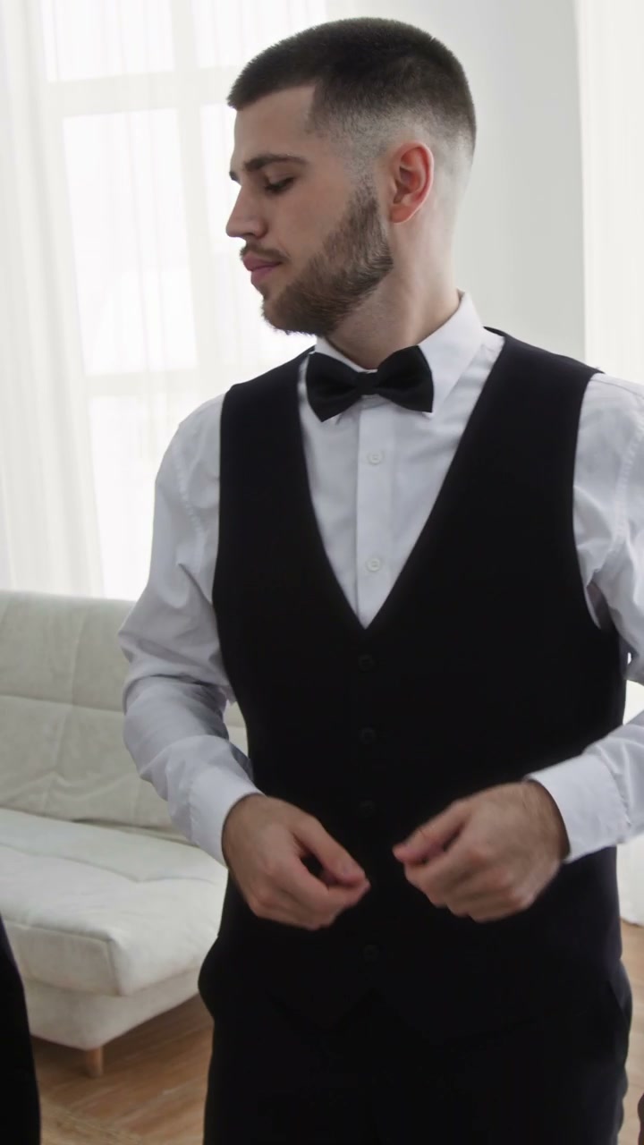 Best Man Helps Groom Get Dressed