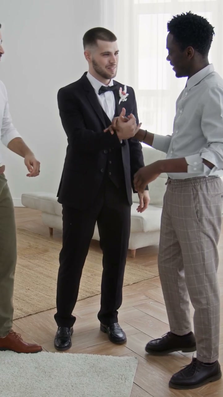 Groom Hugs Friends at Home Wedding Celebration
