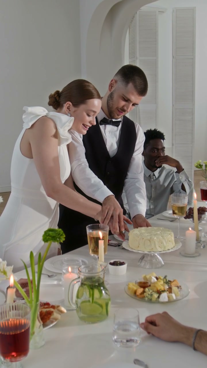Couple Cutting Wedding Cake at Celebration