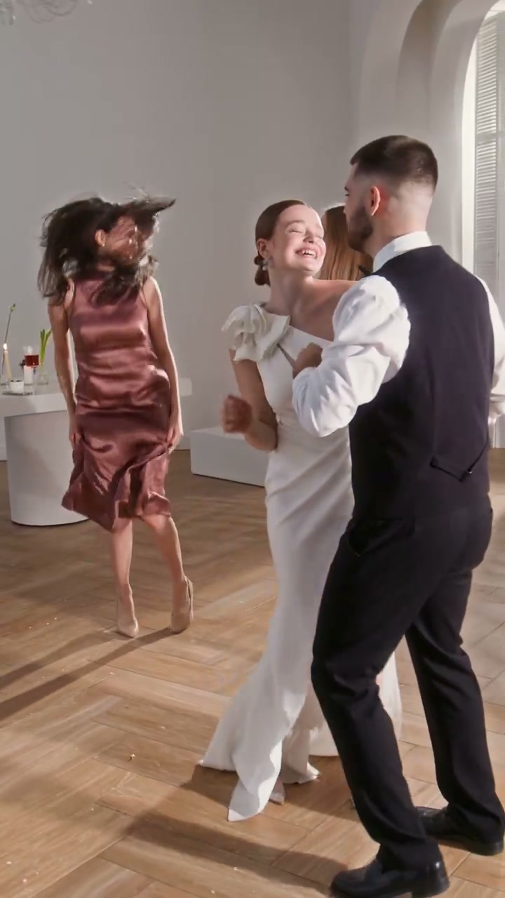 Couple and Friends Dancing at Wedding Party