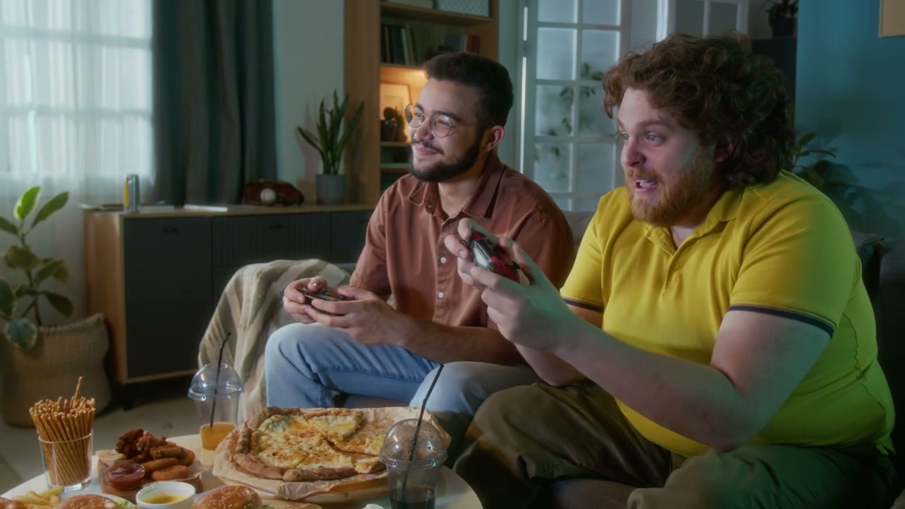 Friends Playing Video Games and Eating Fast Food
