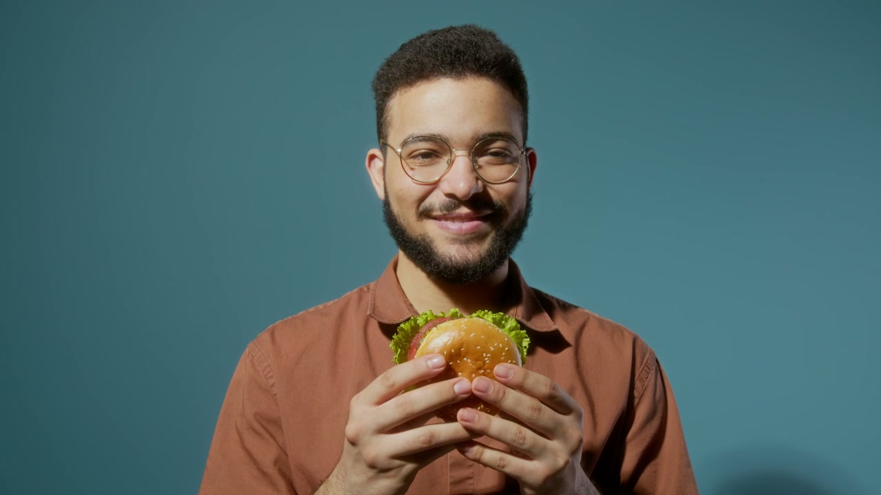 Happy Young Man Holding a Burger
