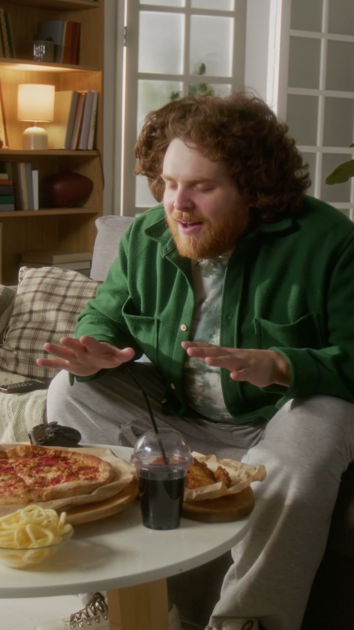 Man Talking with Fast Food in Living Room