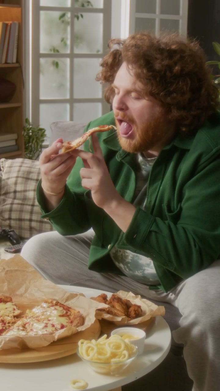 Man Enjoying Pizza and Fast Food