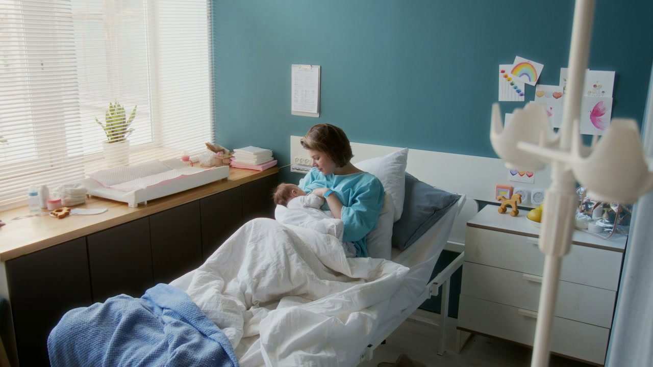 Mother Bonding With Newborn In Hospital Room