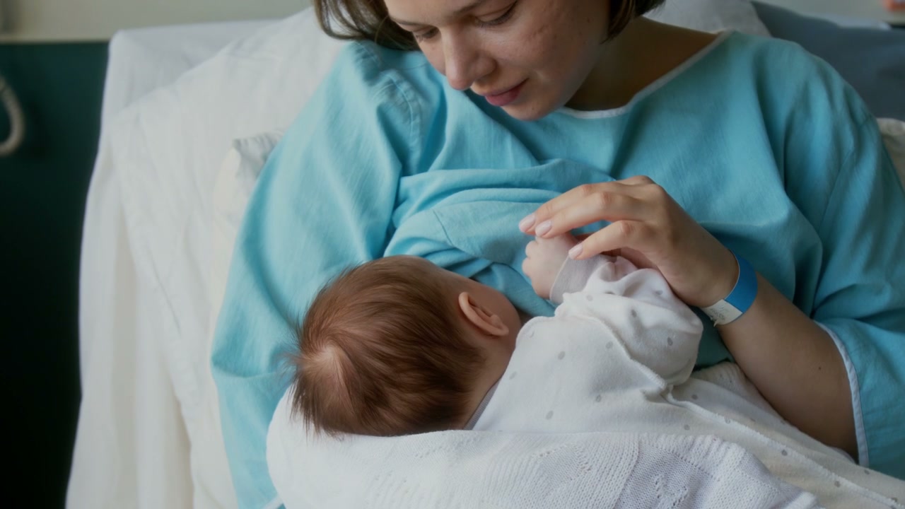 New Mother Breastfeeding Newborn in Hospital