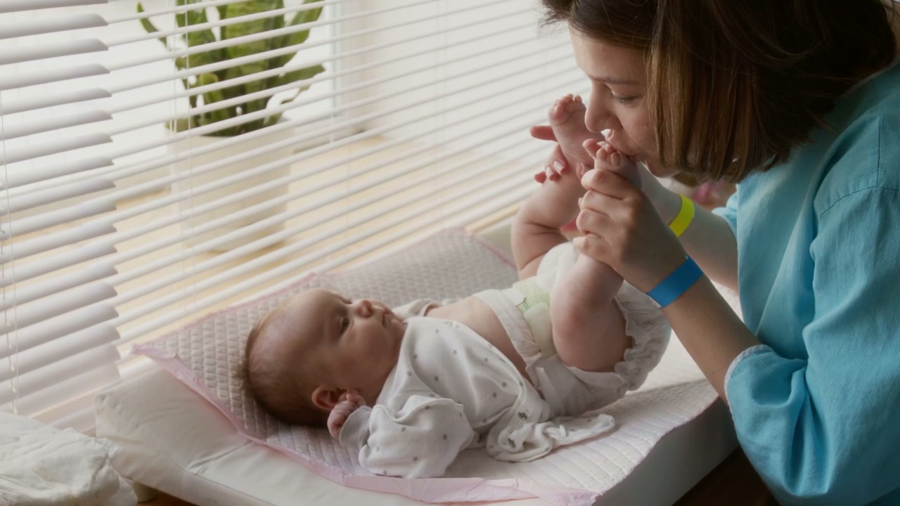 Mother Kissing Newborn's Feet