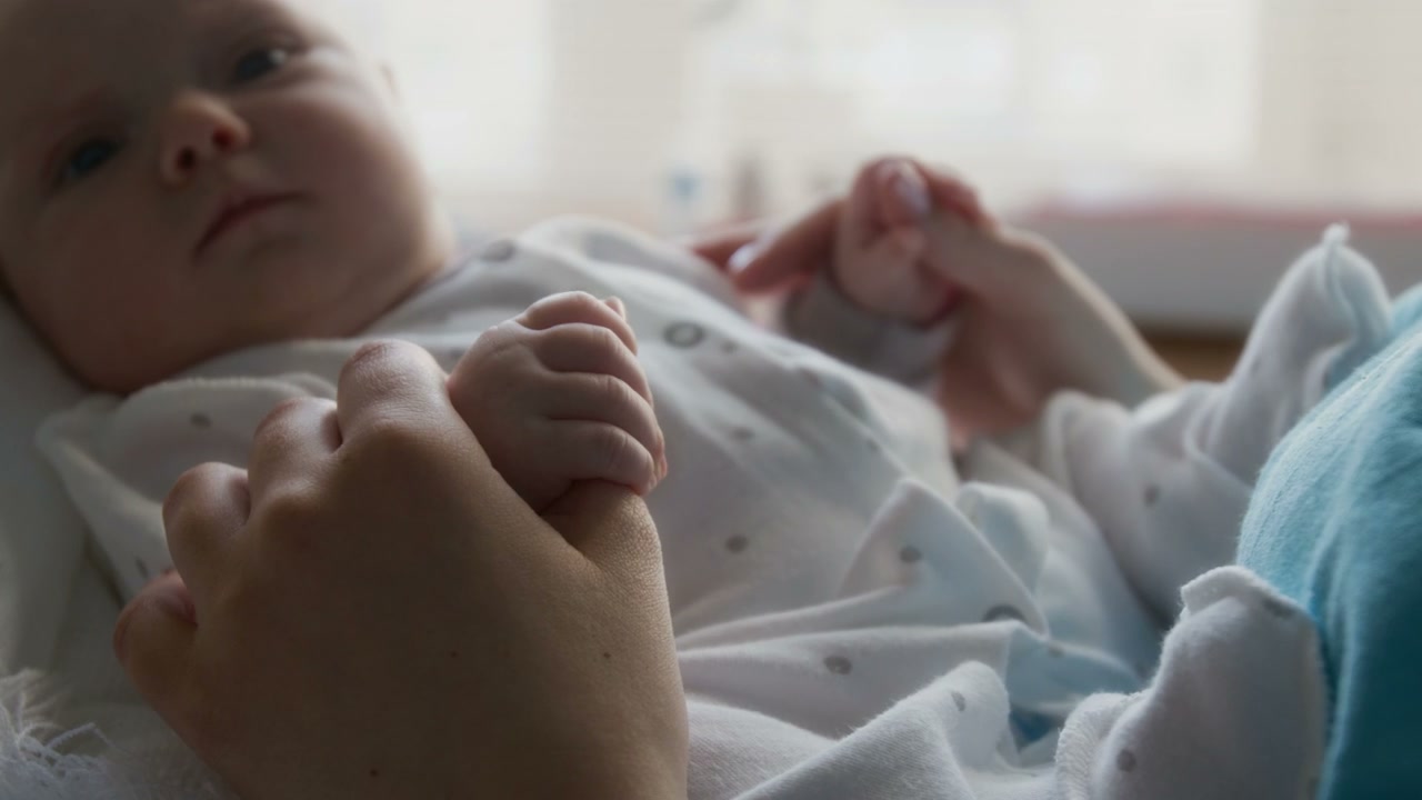 Close-Up of Newborn Baby Holding Parent's Hand
