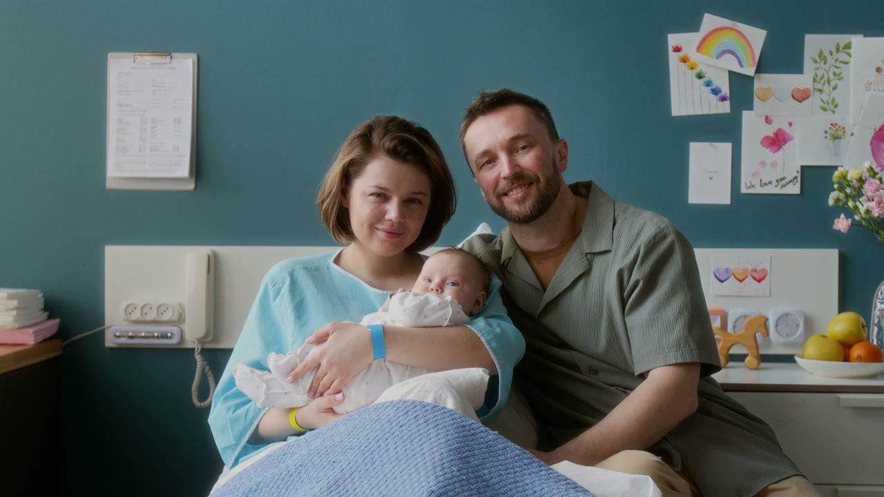 Happy Parents with Newborn Baby in Hospital