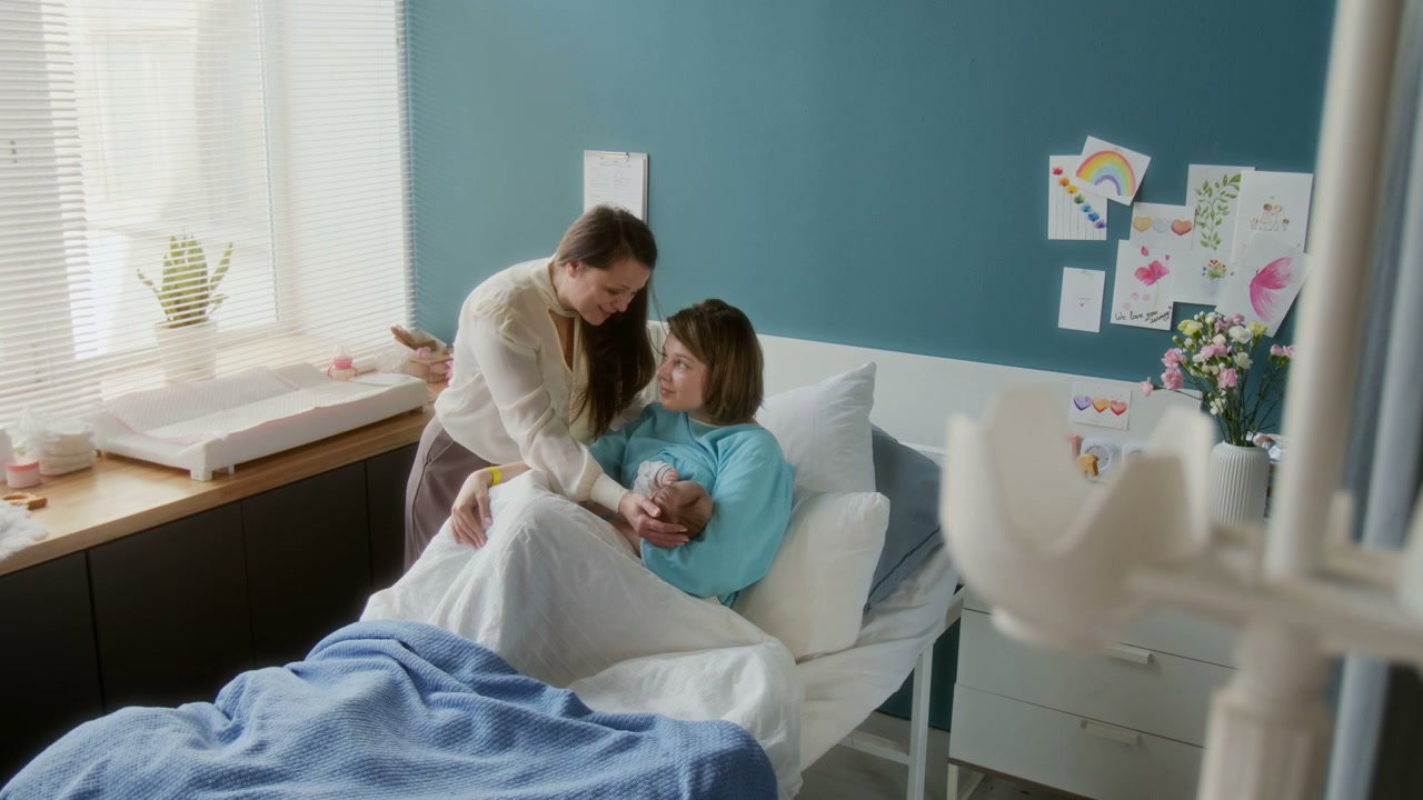 Mother and Relative with Newborn in Hospital
