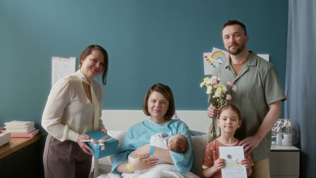 Family Visiting Mother and Newborn in Hospital