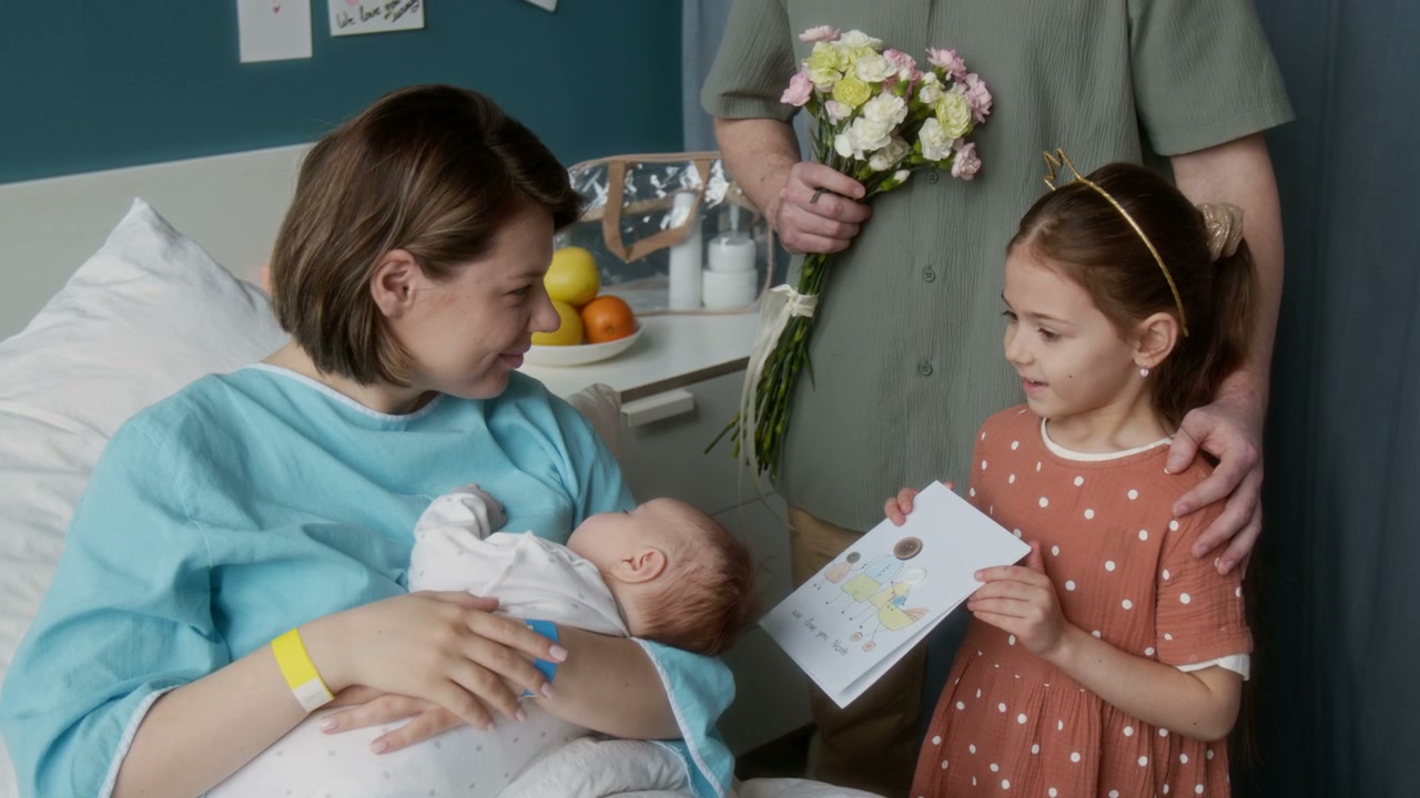 Family Visiting Mother and Newborn in Hospital