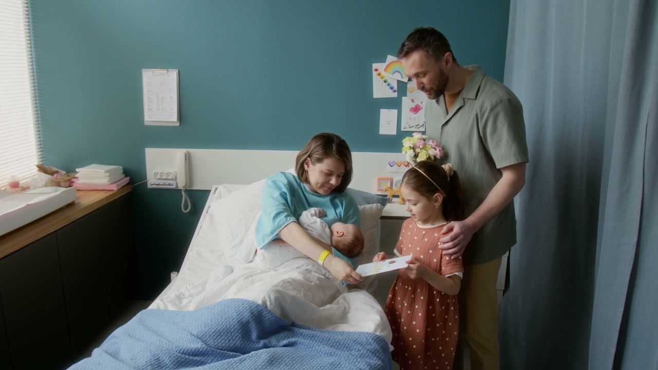 Family Visits Newborn Baby in Hospital Room