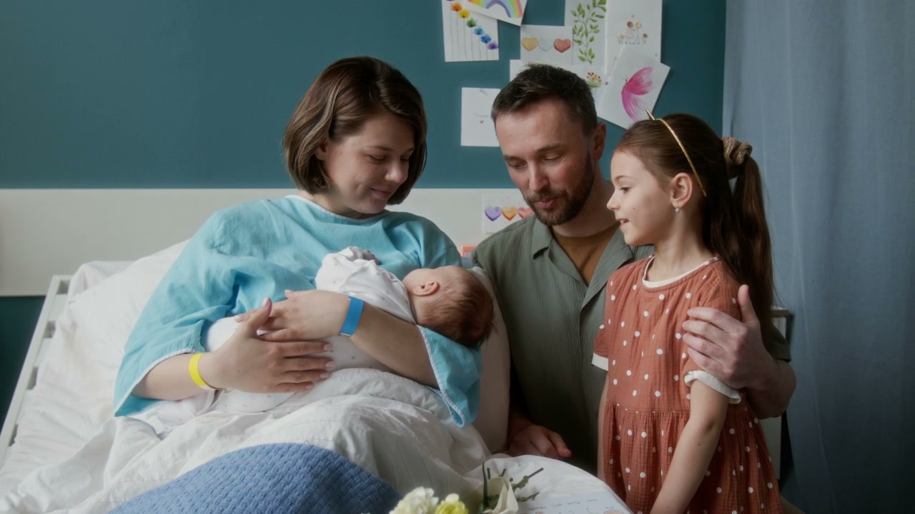 Family Visiting Newborn Baby in Hospital