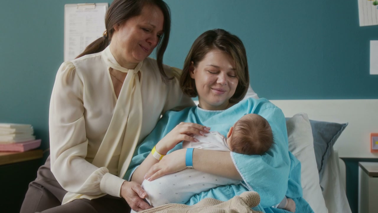 Mother And Grandmother Bond With Newborn Baby