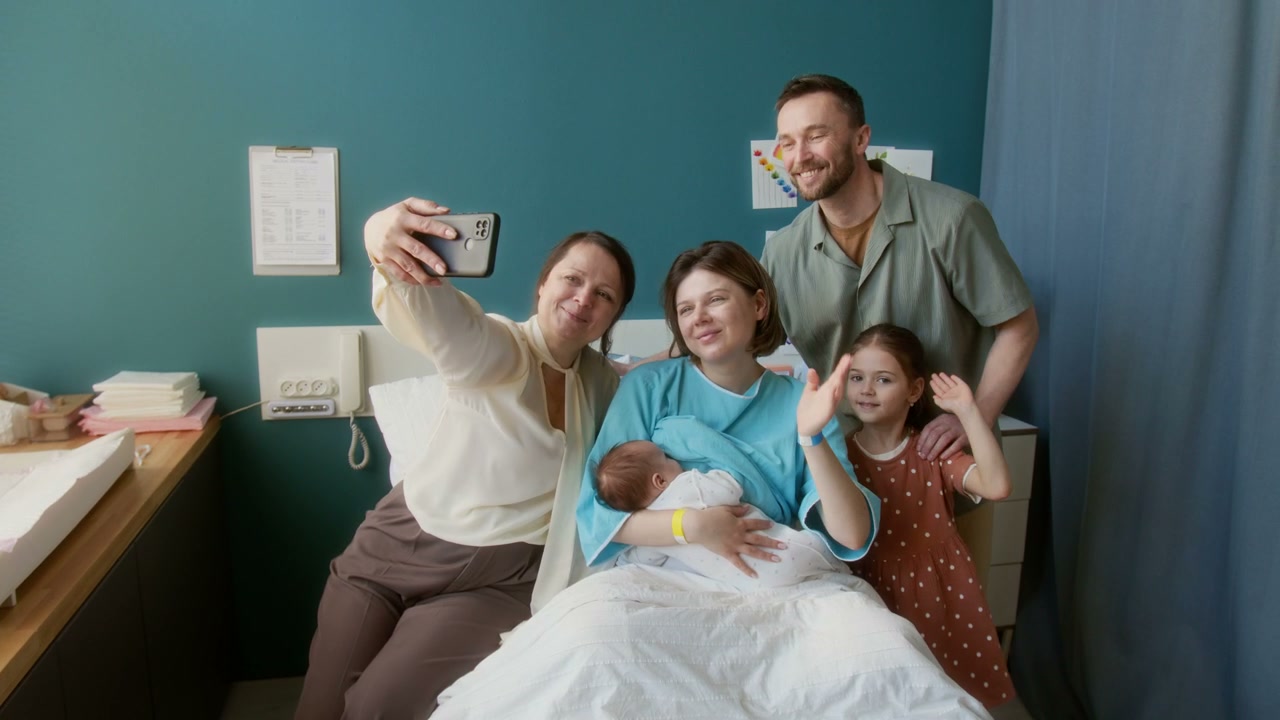 Family Taking Selfie with Newborn and Mother