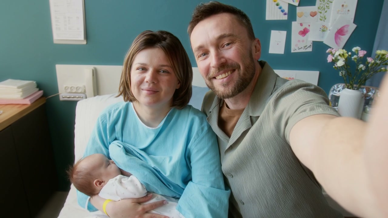 New Parents Take Hospital Selfie with Newborn