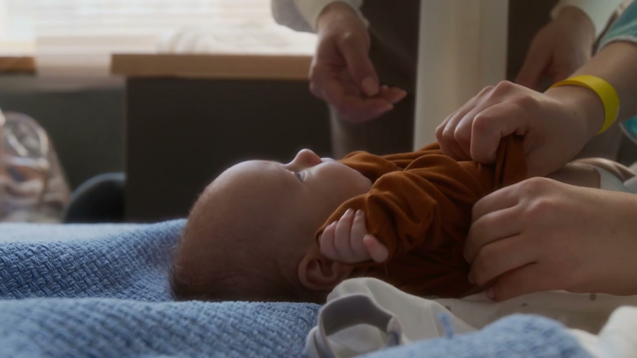 Close Up of Newborn Baby Getting Dressed