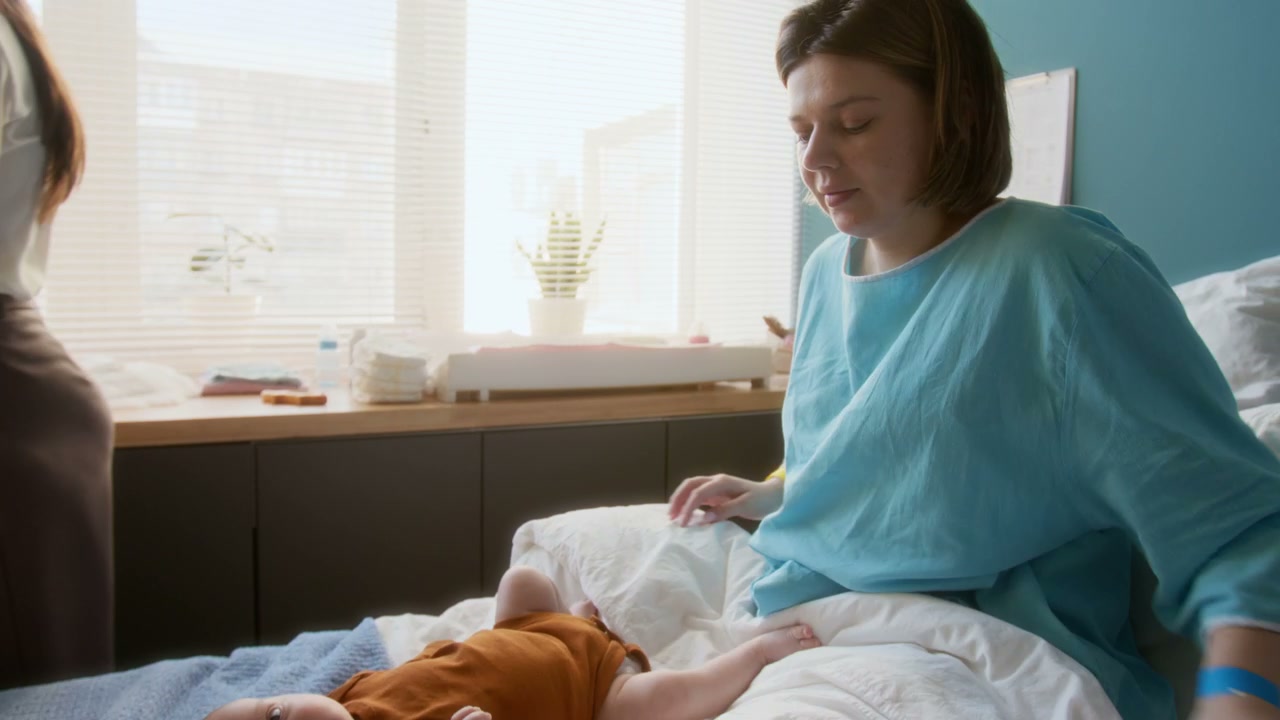 Mother Cares for Newborn Baby in Hospital