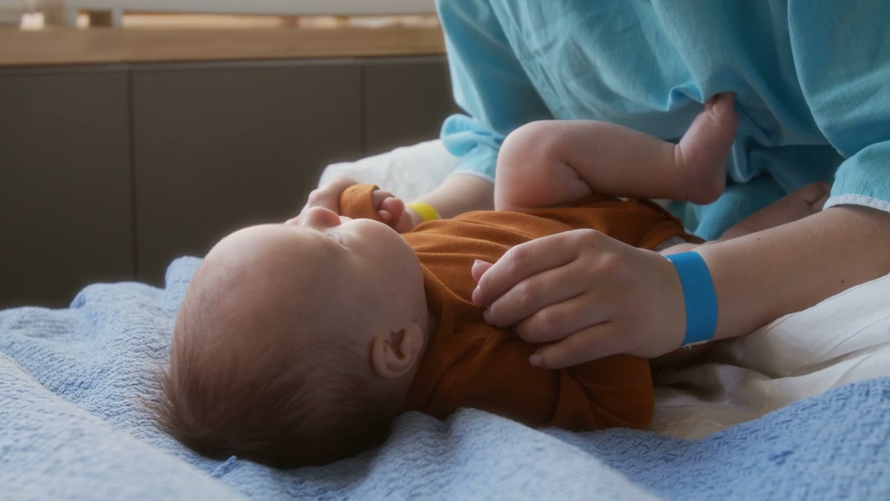 Newborn Baby Looking at Camera with Mother