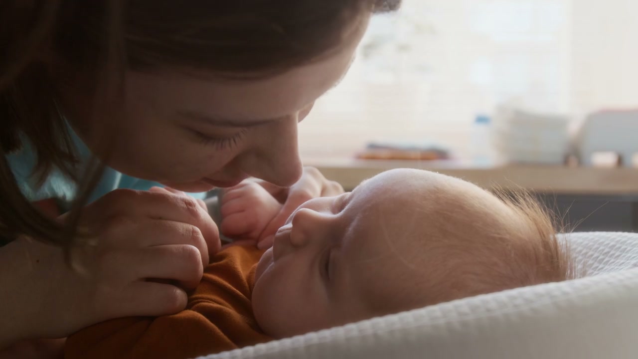 Mother Kisses Newborn Baby's Nose