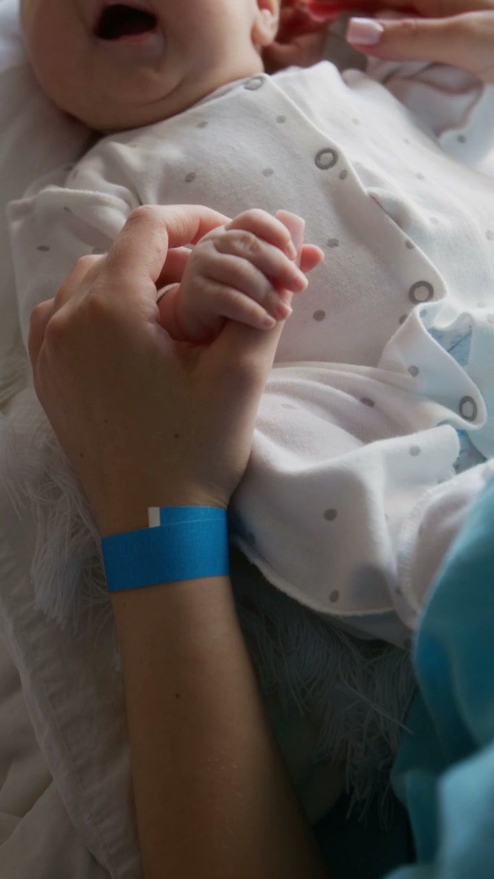 Newborn Baby Holds Mother's Hand