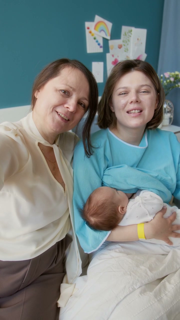 New Mother and Grandmother Take Selfie with Baby