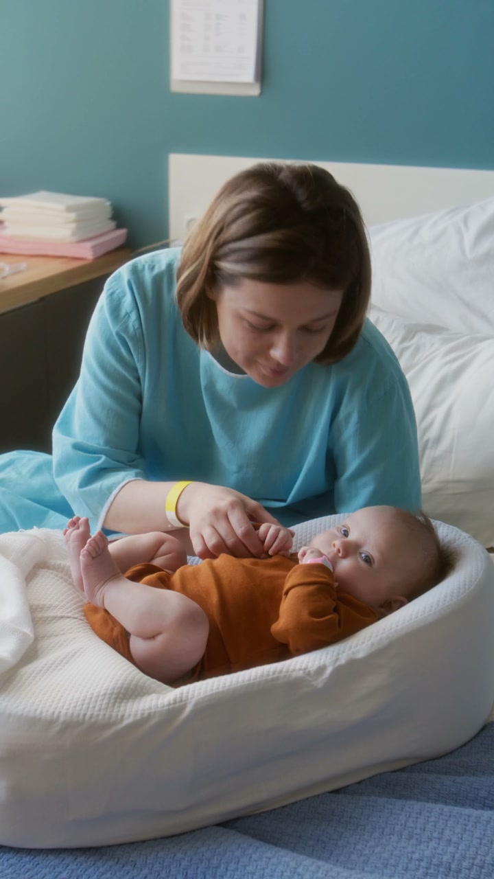 Mother Bonds with Newborn in Hospital Room