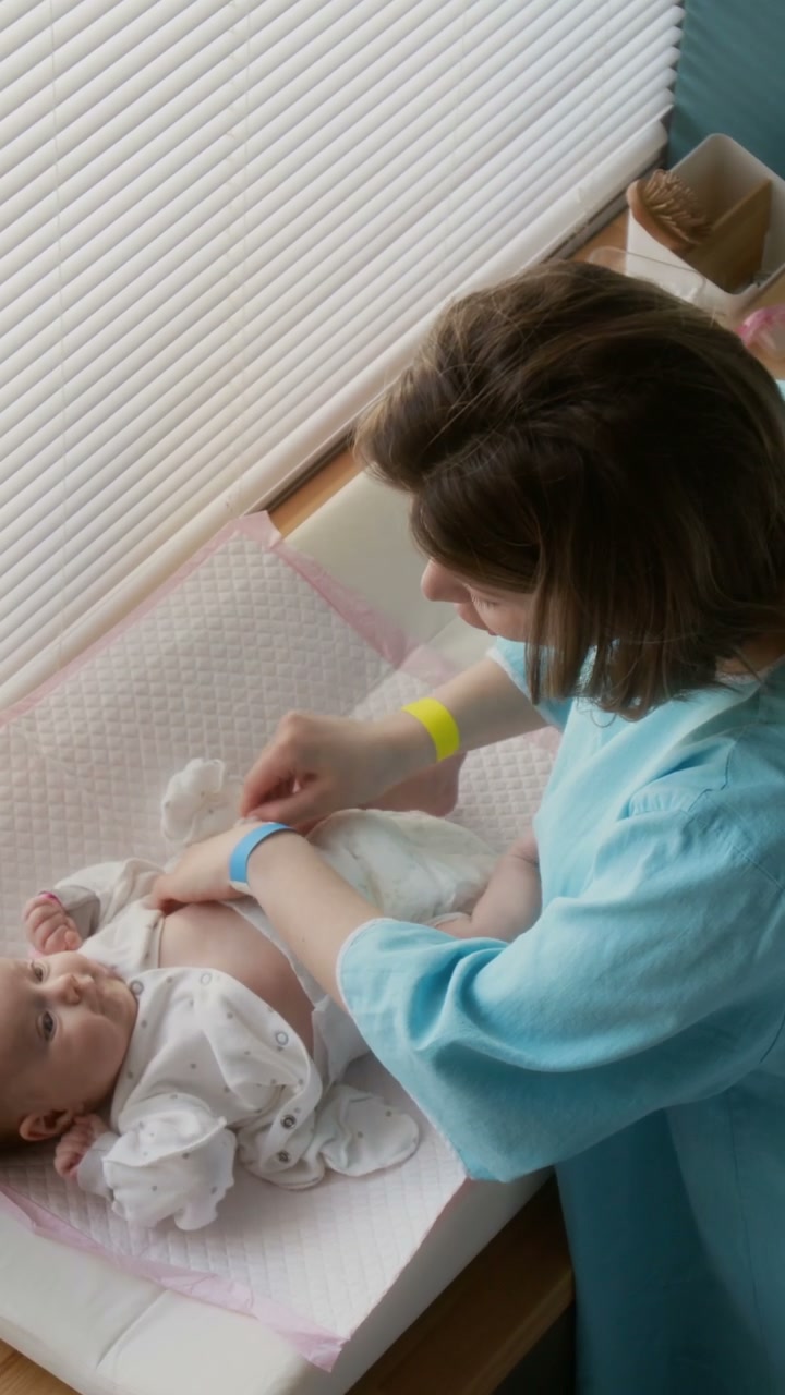 Mother Changing Newborn Diaper