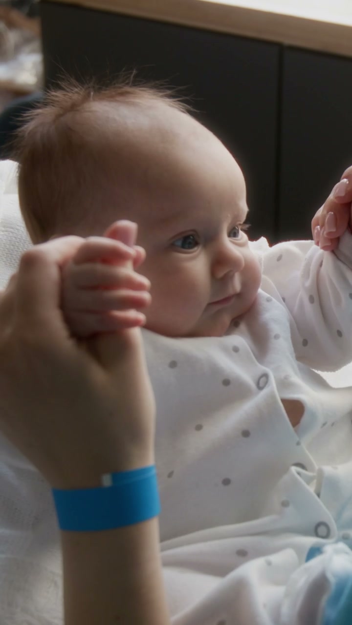 Newborn Baby in Hospital Gripping Finger