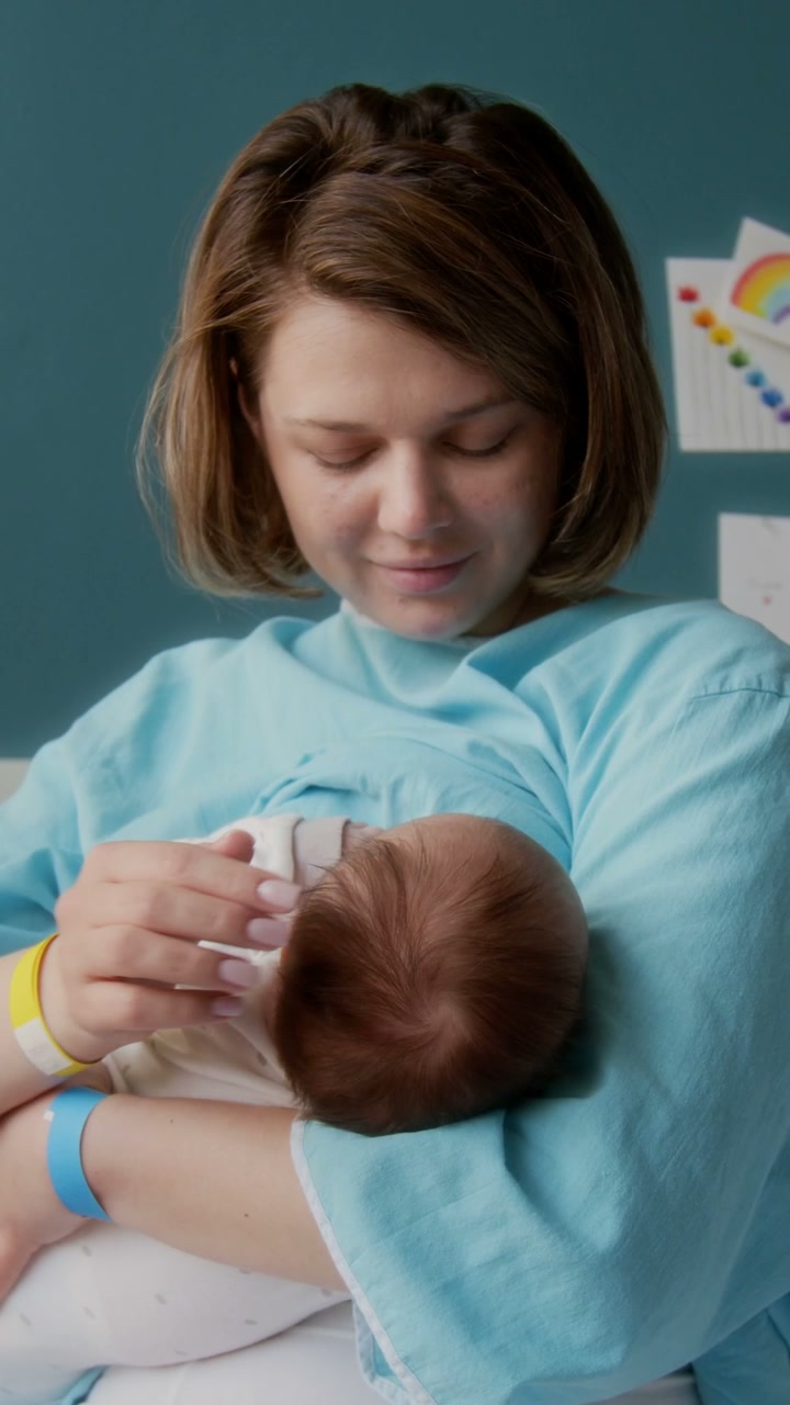New Mother Holding Newborn in Hospital