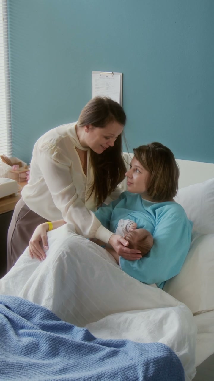 Mother Breastfeeding Newborn with Family Support