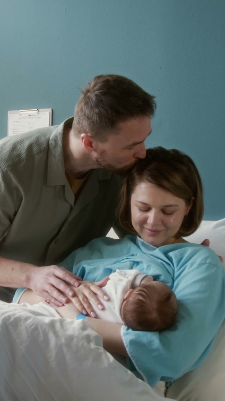 Parents With Newborn Baby in Hospital Room